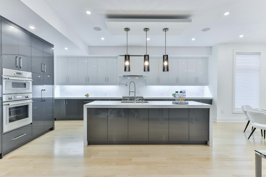 Modern kitchen with gray cabinets and a white island